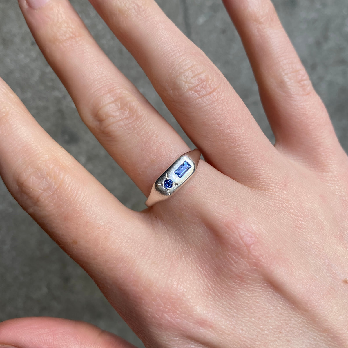 silver long signet ring with a rectangular blue stone and a round blue stone