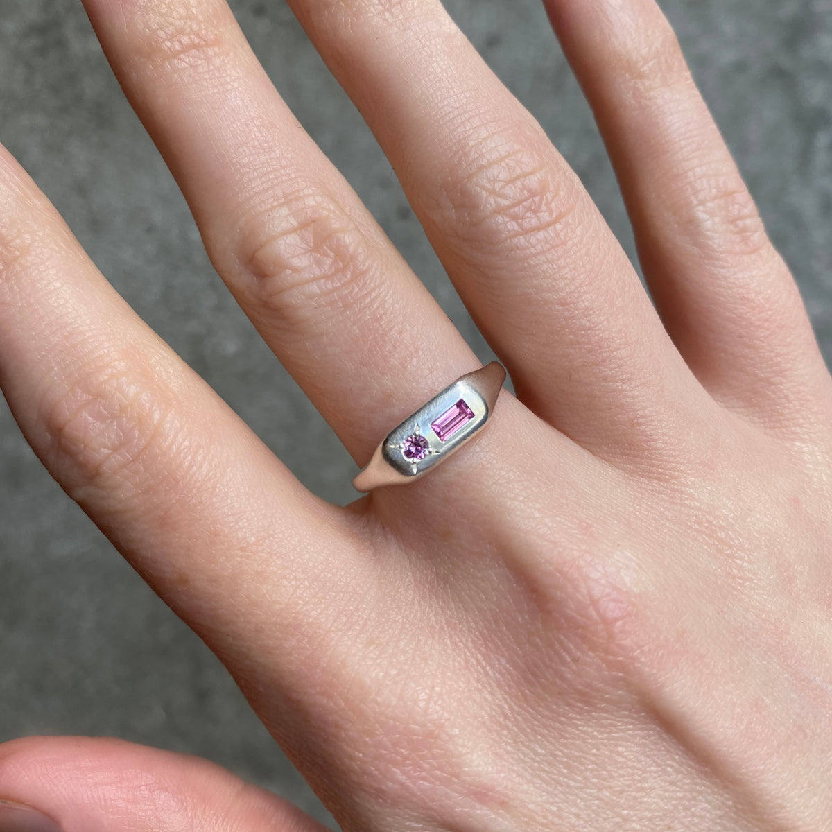 silver long signet ring with a rectangular pink and a round stone