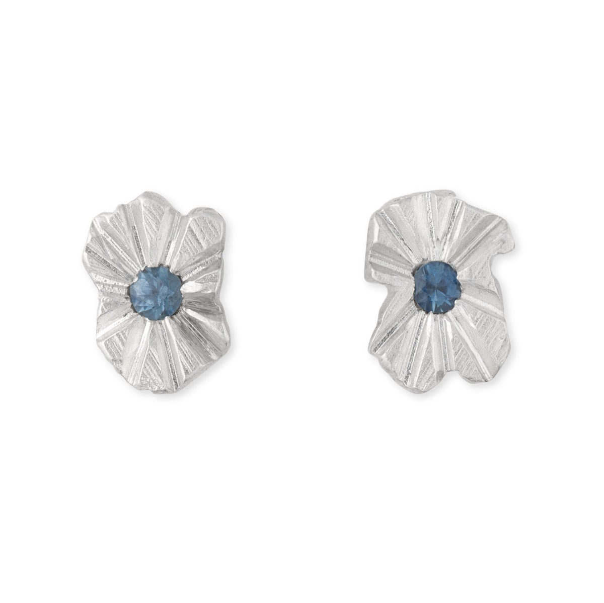 A pair of silver studs with blue sapphires in the centre