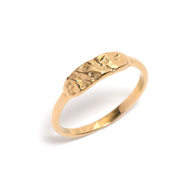 Gold ring with a textured design on a white background