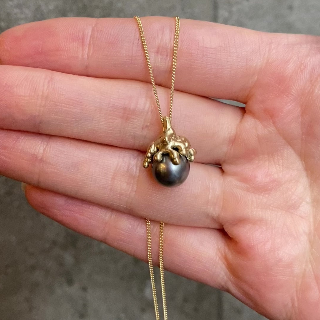 Black Pearl with gold drippy look cap on fine gold chain